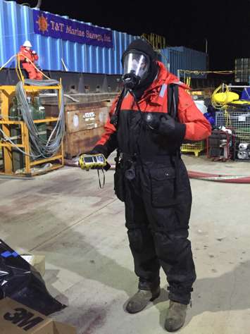 A responder conducts air monitoring throughout lightering operations aboard a work barge at the sunken barge Argo site, Nov. 24, 2015. Precautions are taken to ensure crews are conducting operations in a safe working environment. (U.S. Coast Guard photo by Kurt Kollar, Ohio EPA)