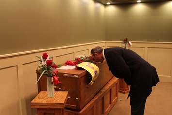 A member of the Kurdish community part of fallen veteran and Wheatley native John Gallagher's repatriation ceremony pays his respects at the Blenheim Community Funeral Home on November 20, 2015. (Photo by Ricardo Veneza)