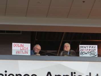 London residents hold up signs against the proposed BRT system at a public meeting at Budweiser Gardens, May 3, 2017. (Photo by Miranda Chant, Blackburn News)