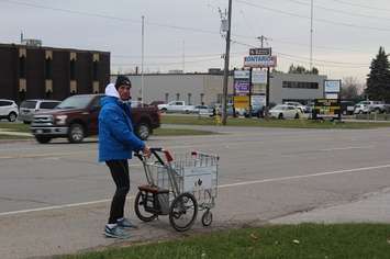 Joe Roberts walking into Chatham, pushing a shopping cart in his Push for Change campaign. November 28, 2016. (Photo by Natalia Vega)