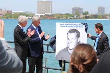 Prime Minister Stephen Harper (middle), Michigan Gov. Rick Snyder (left) and Murray Howe unveil the name of Windsor-Detroit's new bridge, May 14, 2015. (Photo by Mike Vlasveld)
