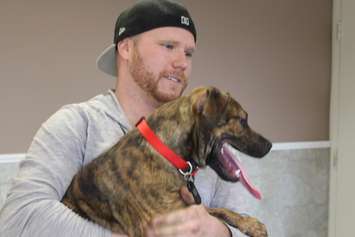 Derek adopts Reno, a puppy brought to the Windsor Essex Humane Society after being severely malnourished, March 26, 2015. (Photo by Jason Viau)