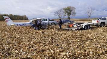 Windsor Flight Club members, including John Cundle, work to take the wings off the aircraft that made an emergency landing in Sarnia last week. October 31, 2017 (Photo by Melanie Irwin)