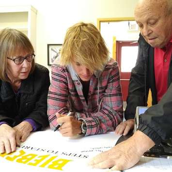 Justin Bieber signing at shirt for display. (Picture courtesy of John Kastner)