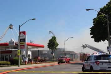 Three aerial trucks helped fight the fire at Le Chef and an auto body shop on Wyandotte St. E in Windsor, May 23, 2016.  (Photo by Adelle Loiselle)