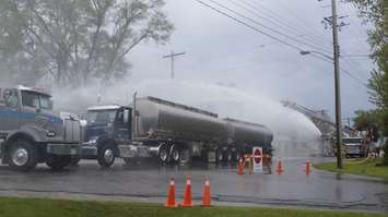 Firefighters spraying two haulers during the 2019 Sarnia Area Disaster Simulation. May 22, 2019. (Photo by Colin Gowdy, BlackburnNews)