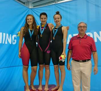 Chatham Y Pool Shark swimmer Madison Broad receives her gold medal in the 50m Backstroke at the Canadian Age Group Championships, July 30, 2015. (Photo courtesy of Bailey Salmon Moskal)