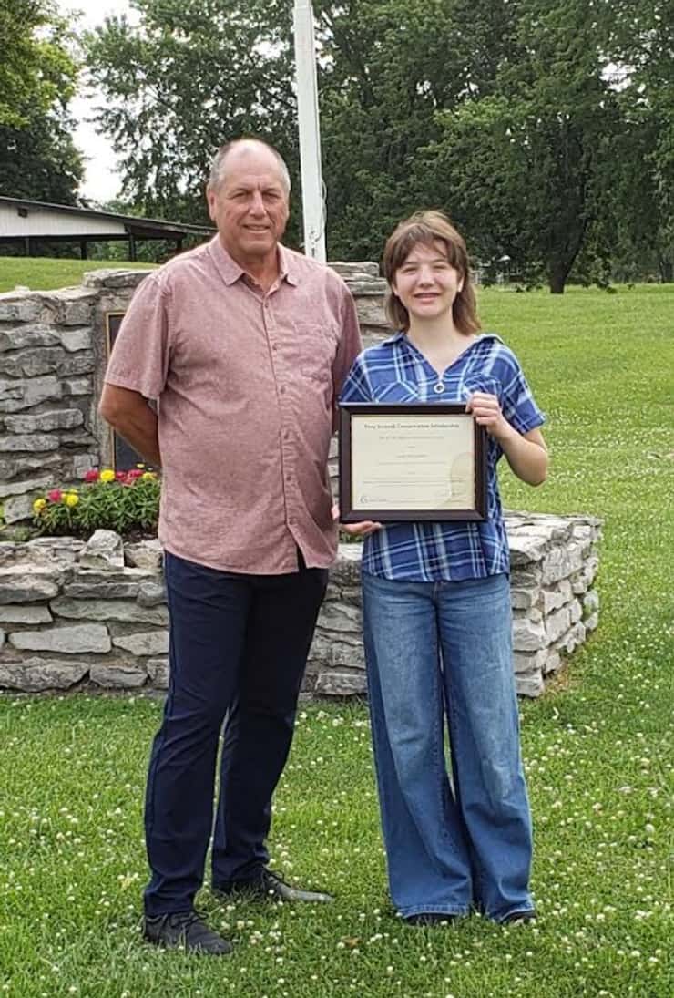 Josie Van Dellen is awarded with the Tony Stranak Conservation Scholarship by St. Clair Region Conservation Authority Chair Greg Grimes. July 2026. (Photo courtesy of the SCRCA)