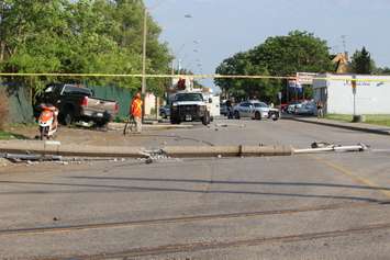 A truck knocks down two hydro poles and smashes through a fence on Drouillard just north of Franklin St., June 10, 2015. (Photo by Jason Viau)