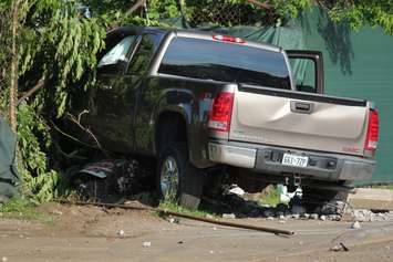 A truck knocks down two hydro poles and smashes through a fence on Drouillard just north of Franklin St., June 10, 2015. (Photo by Jason Viau)