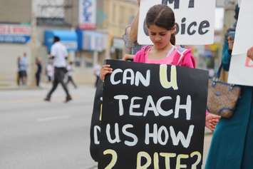 Parents and students hold a sex-ed protest outside NDP Windsor-West MPP Lisa Gretzky's office, June 5, 2015. (Photo by Jason Viau)