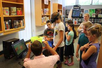Windsor Public Library staff teach elementary school kids about virtual reality gaming at the branch on Seminole St., June 19, 2017. (Photo by Mike Vlasveld)