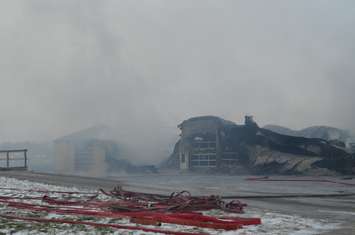 Smoke rises from the ruins (blackburnnews.com photo)
