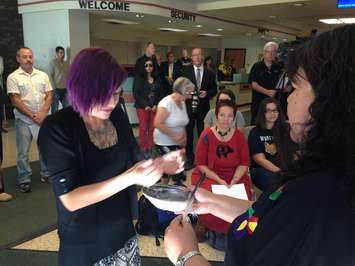 A student takes part in a Smudge Ceremony at St.Clair College, September 22, 2015.  (Photo by Adelle Loiselle)