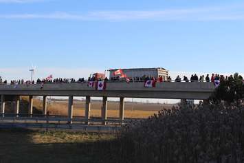 Supporters come out to the Communications Rd. overpass on Hwy. 401 for the repatriation ceremony of fallen veteran and Wheatley native John Gallagher on November 20, 2015. (Photo by Ricardo Veneza)