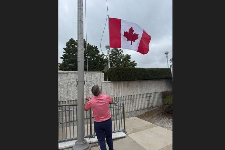 Port Huron City Manager and Chief Administrative Officer James Freed raises a Canadian flag at city hall as a "gesture of support" to Canadian partners. Submitted photo.