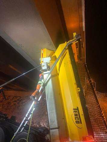 A snow plow stuck under an overpass on Highway 402 outside Sarnia.  23 January 2022.  (Photo by Lambton OPP)