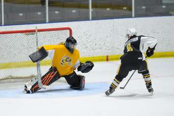 Sarnia Sting goaltending prospect Taya Currie faces Sting first-round pick Angus MacDonell in a scrimmage.  August 30, 2021.  (Metcalfe Photography)