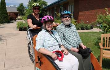 Residents at North Lambton Lodge in Forest take a ride on a trishaw. July 30, 2019. (Photo by County of Lambton)