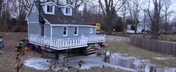 River waters less than a foot away from spilling over the dike and into this residential property. February 8, 2019. (Photo by Greg Higgins)
