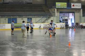 Learning how to ride a bike with the help of volunteers at the iCan Bike Camp in Chatham. July 13, 2016. (Photo by Natalia Vega)