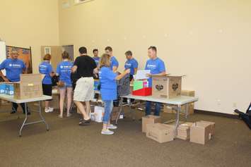 Volunteers filling backpacks with school supplies for local children going back to school. August 29, 2016. (Photo by Natalia Vega)
