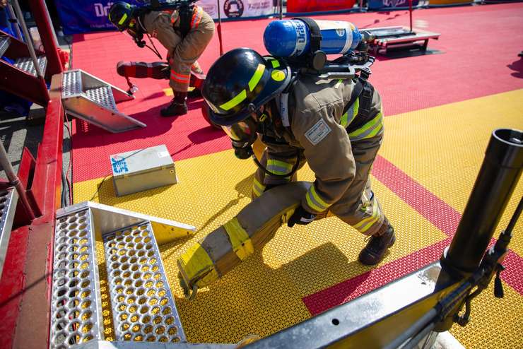 A Lambton College fire student prepares to climb the stairs carrying hose at the 2023 Canadian FireFit National and World Championships. Image courtesy of Lambton College.