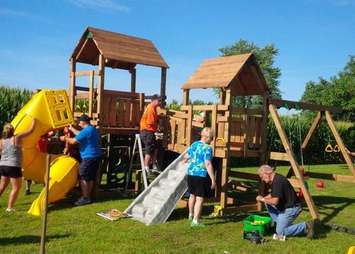 Volunteers putting on the finishing touches for Michael's playset. (Photo courtesy of Chatham-Kent police)