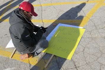 Emilena Cornelius,of Oneida Nation of the Thames, creates a sign for a solidarity march with those in North Dakota fighting an oil pipeline, November 9, 2016. (Photo by Miranda Chant, Blackburn News.)