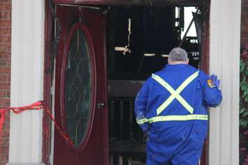 Fire investigators comb through a house on Spago Cres. after a weekend blaze, March 30, 2015. (Photo by Jason Viau)