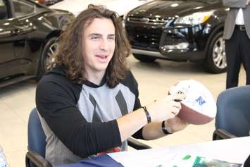 Luke Willson of the Seattle Seahawks signs autographs at Performance Ford in Windsor, April 9, 2015. (Photo by Mike Vlasveld)