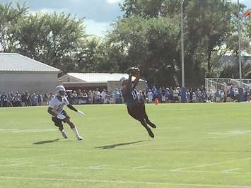 Lions receiver Calvin Johnson makes a catch in front of defensive back Darius Slay at Training Camp. (Photo by Scott Despins)