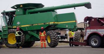Members of Preferred Towing placing new tires on a John Deere combine on London Line in Sarnia. December 12, 2018. (Photo by Colin Gowdy, BlackburnNews)