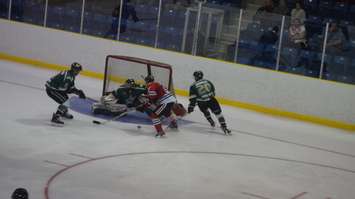 Jake Vince tries to stuff the lose puck by St. Thomas goalie Dan Black. (Photo by Jake Jeffrey)