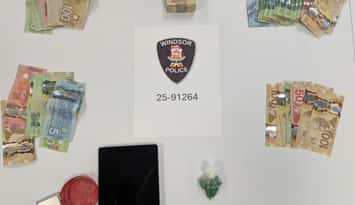 Suspected fentanyl, cash, and other items confiscated in a west Windsor raid are seen on November 19, 2025. Photo provided by Windsor police.