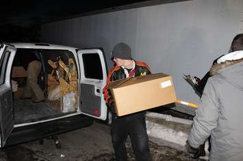 Loading the boxes of toys into the vehicles for delivery. December 20, 2016. (Photo by Natalia Vega)