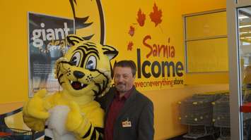 Owner Leo Suglio posts with Friendly, the Giant Tiger inside London Road retail store June 5, 2015 (BlackburnNews.com Photo by Briana Carnegie)