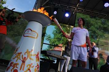 Olympic boxer Mary Spencer carries the flame during the Pan Am Torch Relay in Windsor, June 16, 2015. (Photo by Jason Viau)