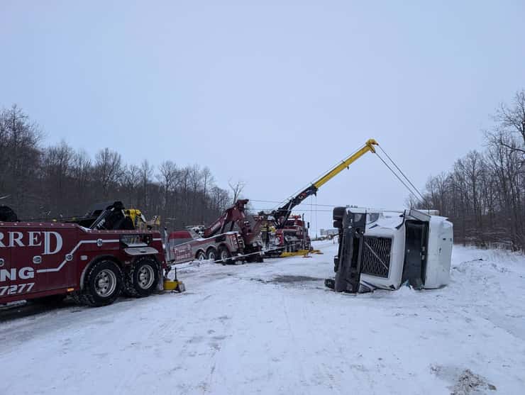 Preferred Towing operators trying to put a transport truck right side up. (Photo courtesy of Collin Vandenheuvel via Facebook)