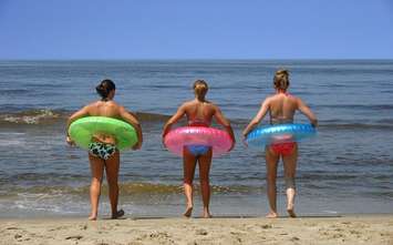 Three people on a beach. File photo courtesy of © Can Stock Photo / keeweeboy.