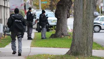 Windsor police investigate a man barricaded inside of an apartment on the corner of Lincoln Rd. and Richmond St., November 12, 2014. (photo by Mike Vlasveld)