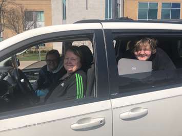 Rickie Soulliere (front seat) a Grade 10 student at St. Patrick’s Catholic High School and her sister Makayla (back seat) a Grade 9 student with their grandmother Wanda Soulliere are shown after picking up their Board-issued Chromebook at St. Patrick’s Catholic High School on Wednesday, April 8. (Photo courtesy of the Lambton Kent District School Board)