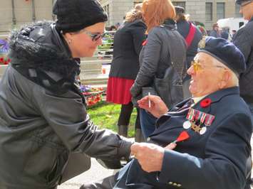 Second World War veteran Michael Sydorko shows a London woman his French Legion of Honour medal at the Remembrance Day ceremony at the Cenotaph in Victoria Park in London, November 11, 2016. (Photo by Miranda Chant, Blackburn News.)