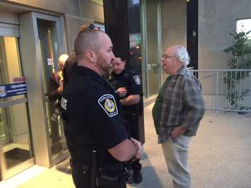 Sarnia Police escort a man out of Sarnia City Hall. Monday, October 24, 2016. BlackburnNews.com photo by Melanie Irwin