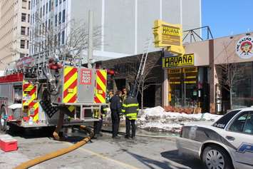 Windsor firefighters respond to a blaze at Havana Smoke Shop & Convenience in the 500-block of Ouellette Ave. downtown, February 23, 2015. (Photo by Mike Vlasveld)