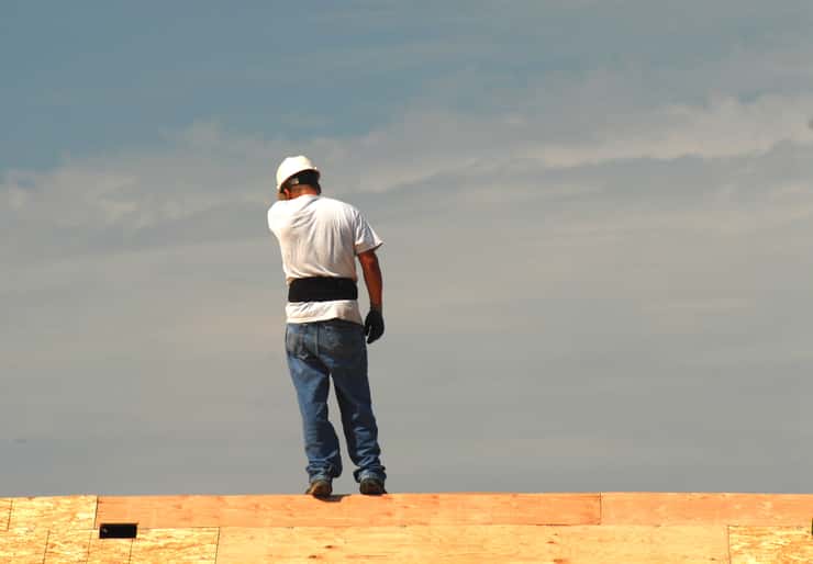 Roofer working on a roof on a hot summer's day. Can Stock Photo / HHLtDave5