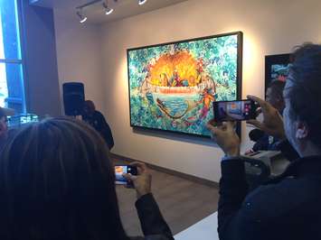 Aamjiwnaang Chief Joanne Rogers helps artist John Williams unveil his painting titled 