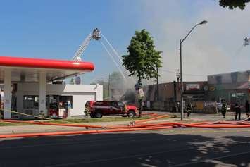 At least six streams of water help put out the fire at Le Chef Restaurant and Downtown Auto Service on Wyandotte St. E, May 23, 2016.  (Photo by Adelle Loiselle)
