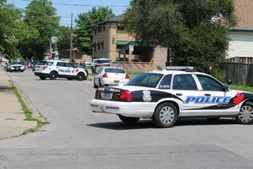 Windsor police swarm the 900 block of Chatham St. E after reports of a break and enter. (Photo by Jason Viau)