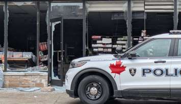 A Windsor police vehicle sits outside a burned storefront on Glengarry Avenue near Wyandotte Street East in Windsor, September 24, 2025. Photo by Mark Brown/WindsorNewsToday.ca.